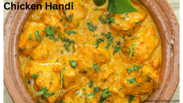 A bowl of creamy Chicken Handi garnished with fresh coriander and served with naan, showcasing rich gravy and tender chicken pieces.